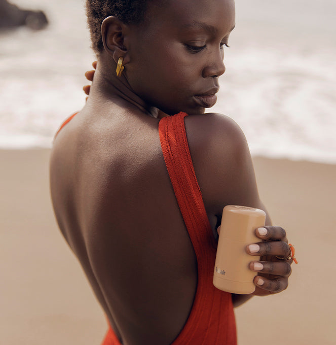 Model-holding-Natural-Deodorant_in-Santal-Bloom_Beach_3000x.jpg